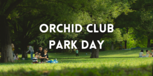 families relax on a green lawn beneath trees. White lettering says "orchid club park day"